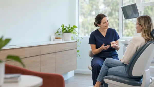 Dentist discussing treatment options with a patient in a modern dental clinic