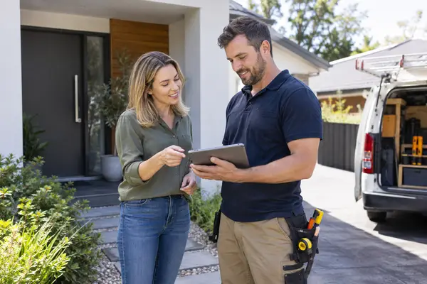 Homeowner reviewing a project quote with a tradesperson